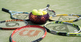 Violet Hobnail Bowl on a tennis court and surrounded by tennis rackets