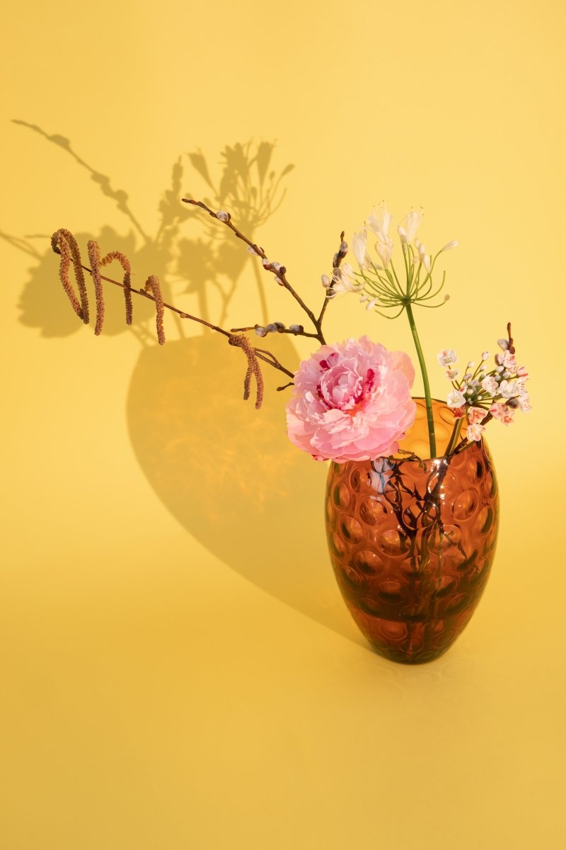 Violet Kugel Vase Tall with pale pink flowers and a light yellow background