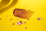 Underlay Violet Hobnail Tumblers on a yellow ground surrounded by flower petals 